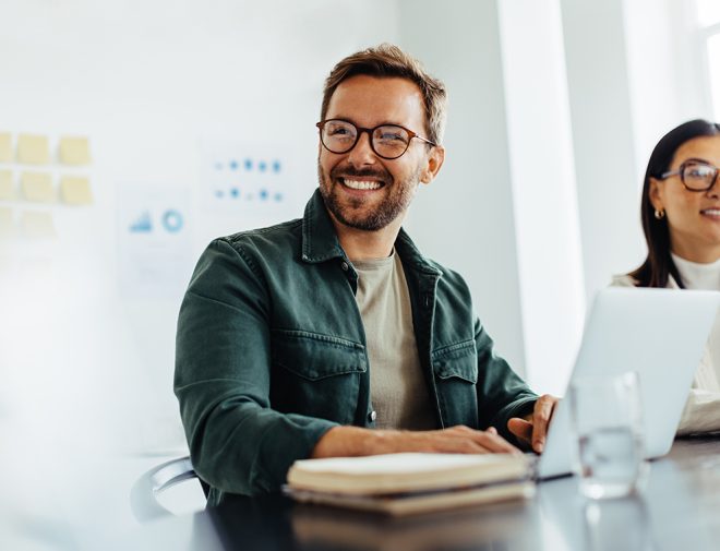 Man sitting at his laptop and smiling