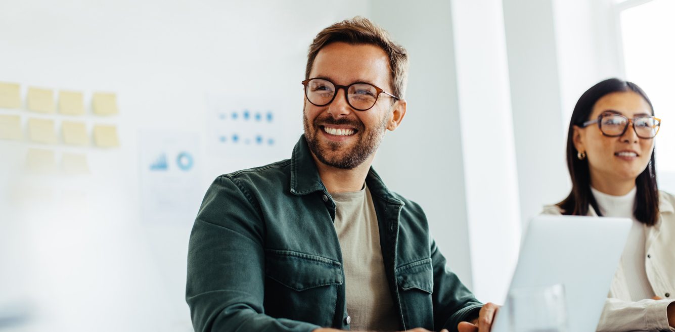 Man sitting at his laptop and smiling