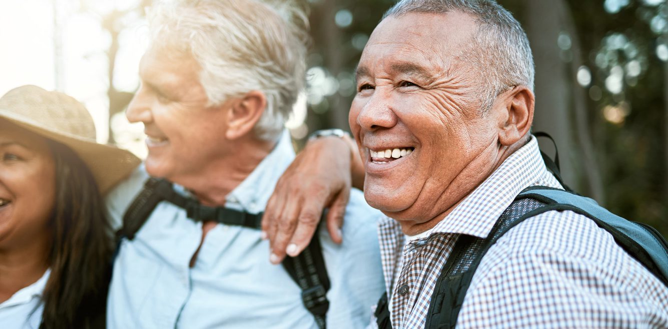 An older man with friends hiking