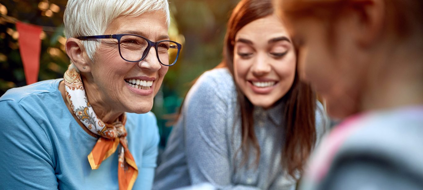 An older woman smiling at someone