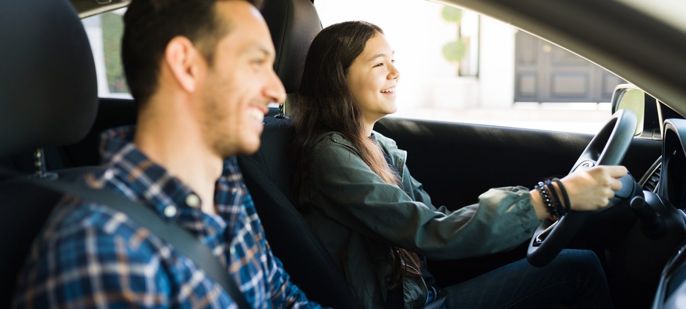 A father teaching his teen daughter to drive