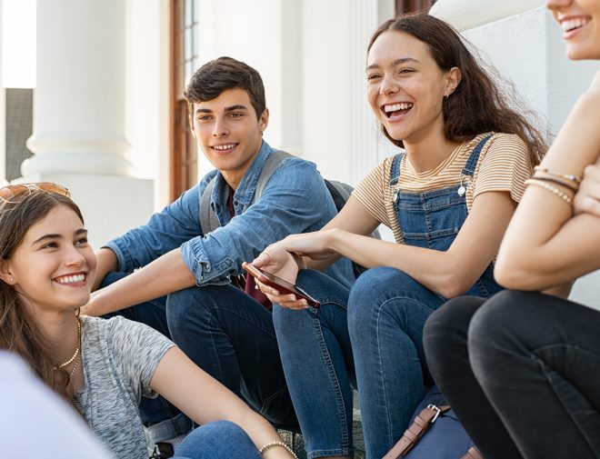 A group of teens sitting a talking