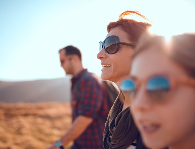 A family in sunglasses hiking