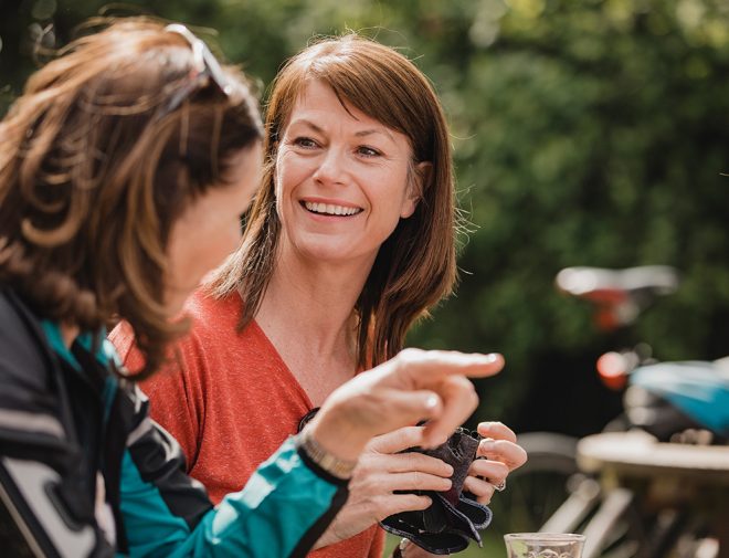 A middle-aged woman smiling at her friend
