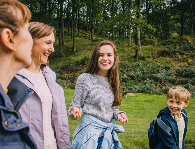 A young woman walking with her family