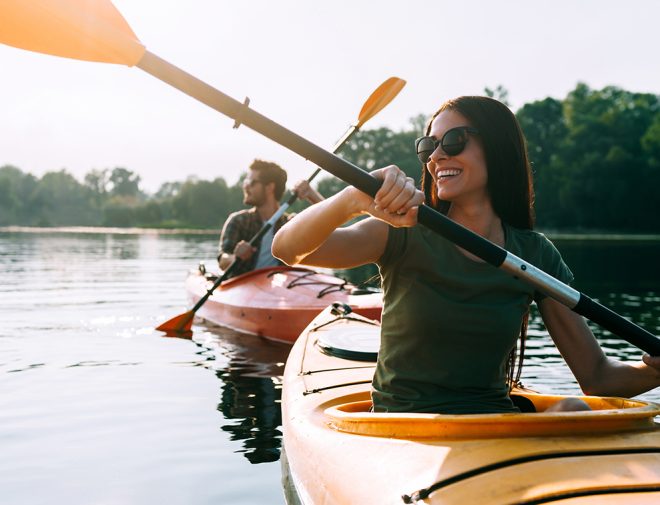 A woman and a man kayaking in a lake