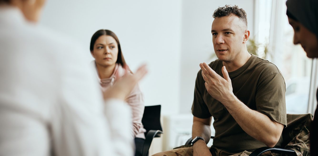 Image of a military veteran talking in group therapy