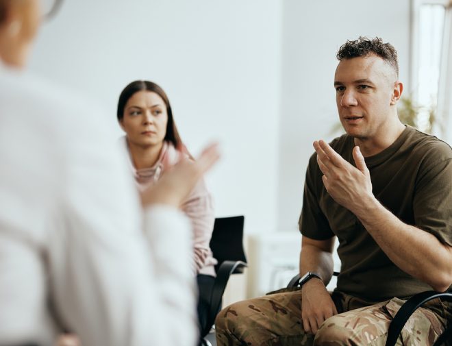 Image of a military veteran talking in group therapy